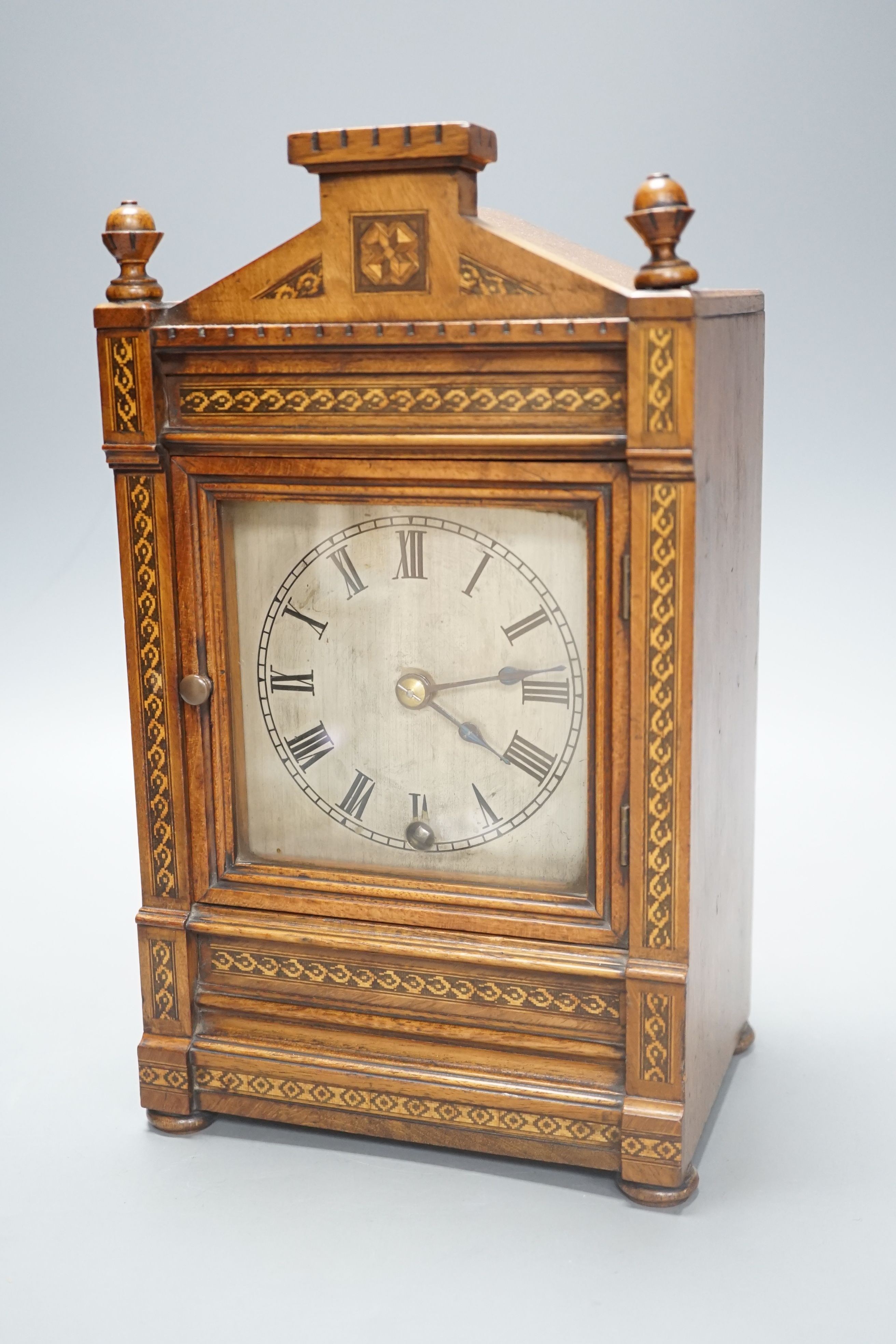 A late 19th century mantel clock in a walnut and Tunbridgeware banded case